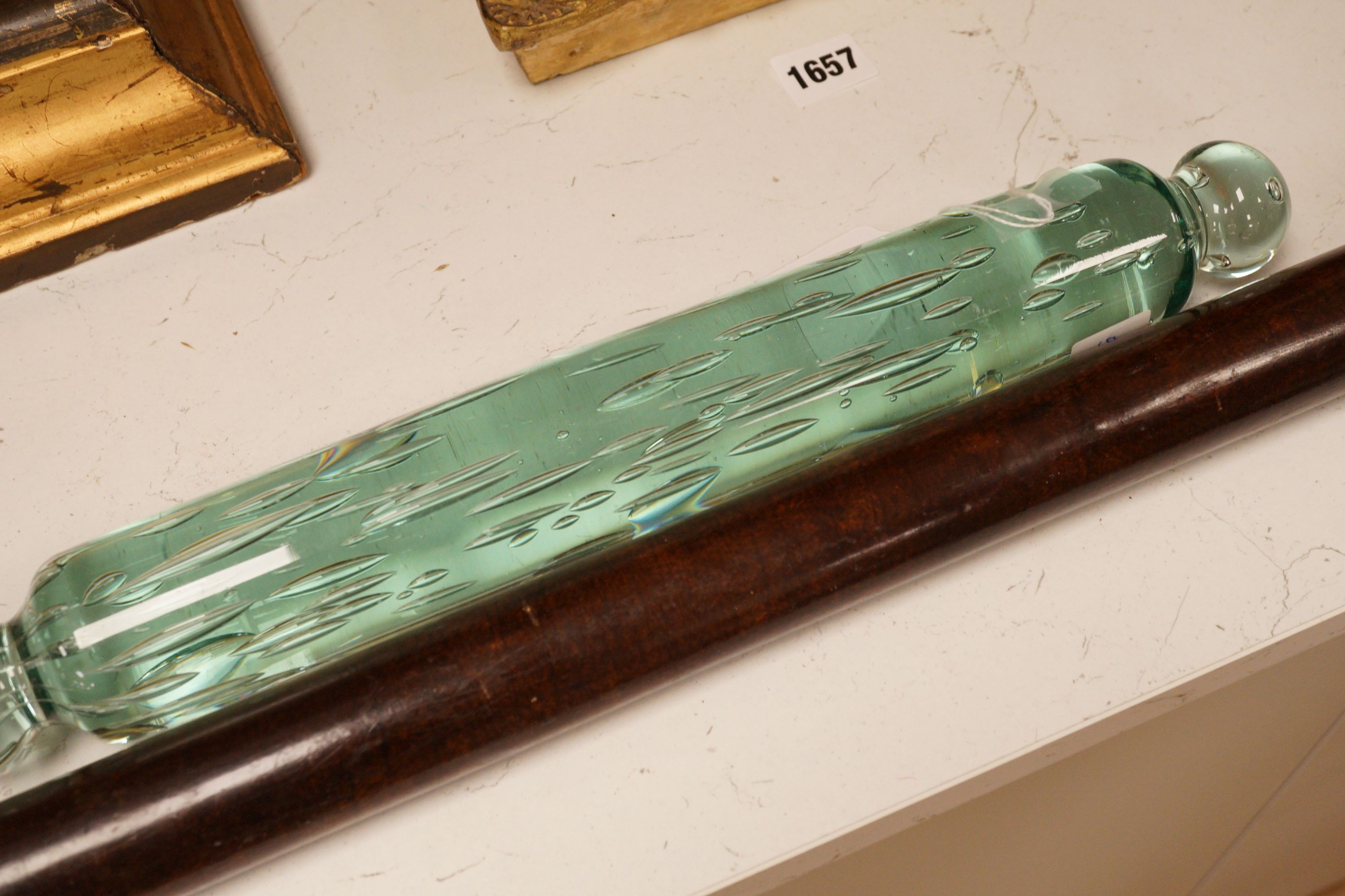 A Victorian glass rolling pin together with a turned wooden example, widest 82cm (2)